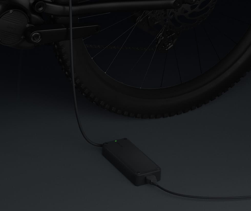 Avinox e-bike battery charger connected to a bicycle.